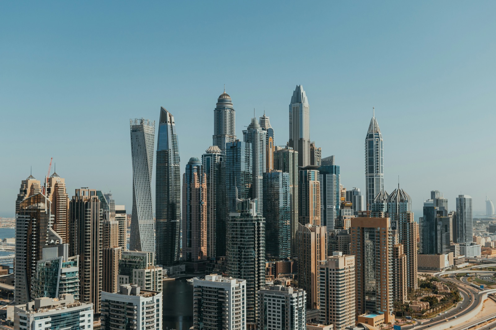 Dubai Marina skyline in daylight — the mid-market landscape where the emirate's two-year agentic AI adoption programme now applies.