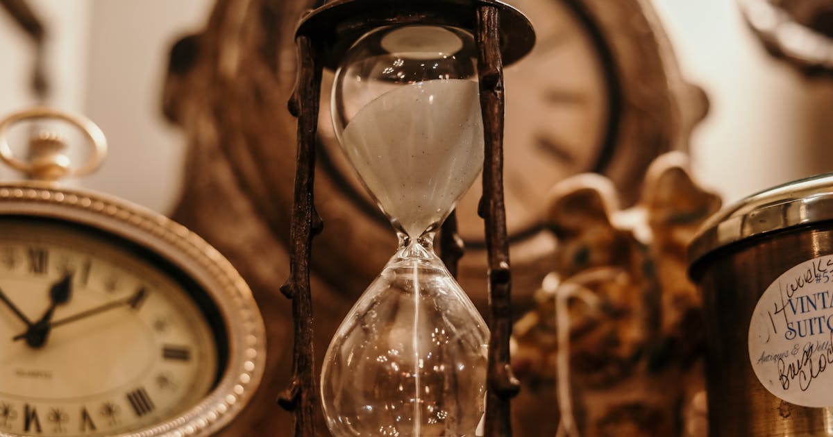 Hourglass running out of sand on a desk — time slipping away during procurement