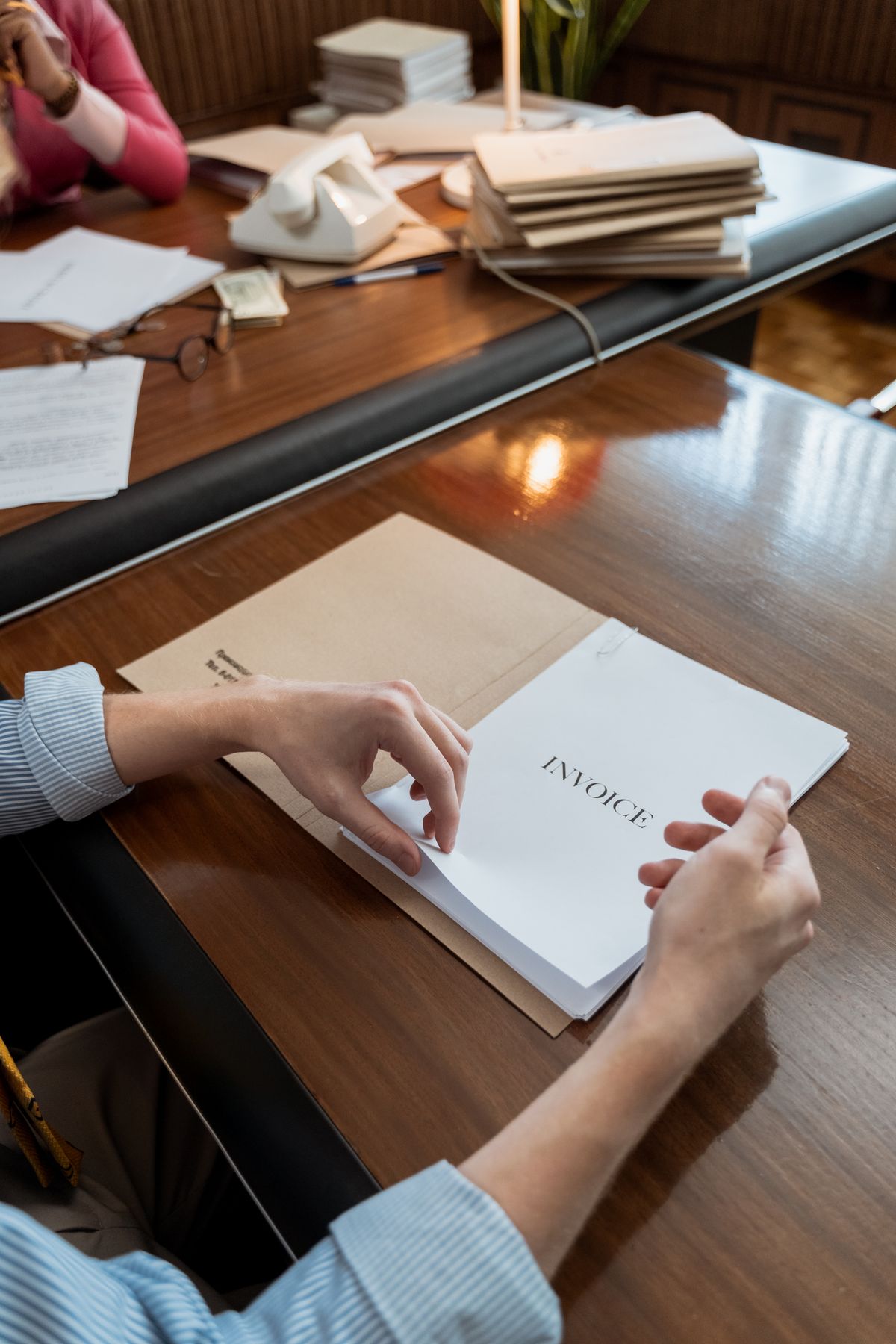 An invoice document being processed at an office desk